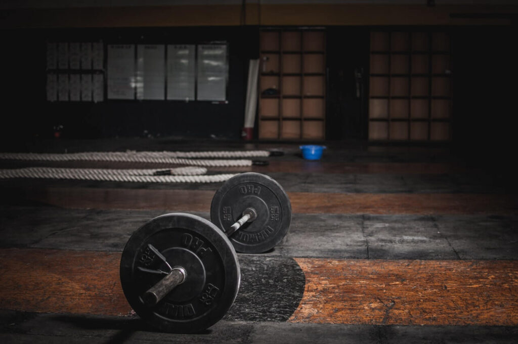 Top 10 Mistakes People Make in the Gym (and How Pride Gym Helps You Avoid Them) barbell on the floor
